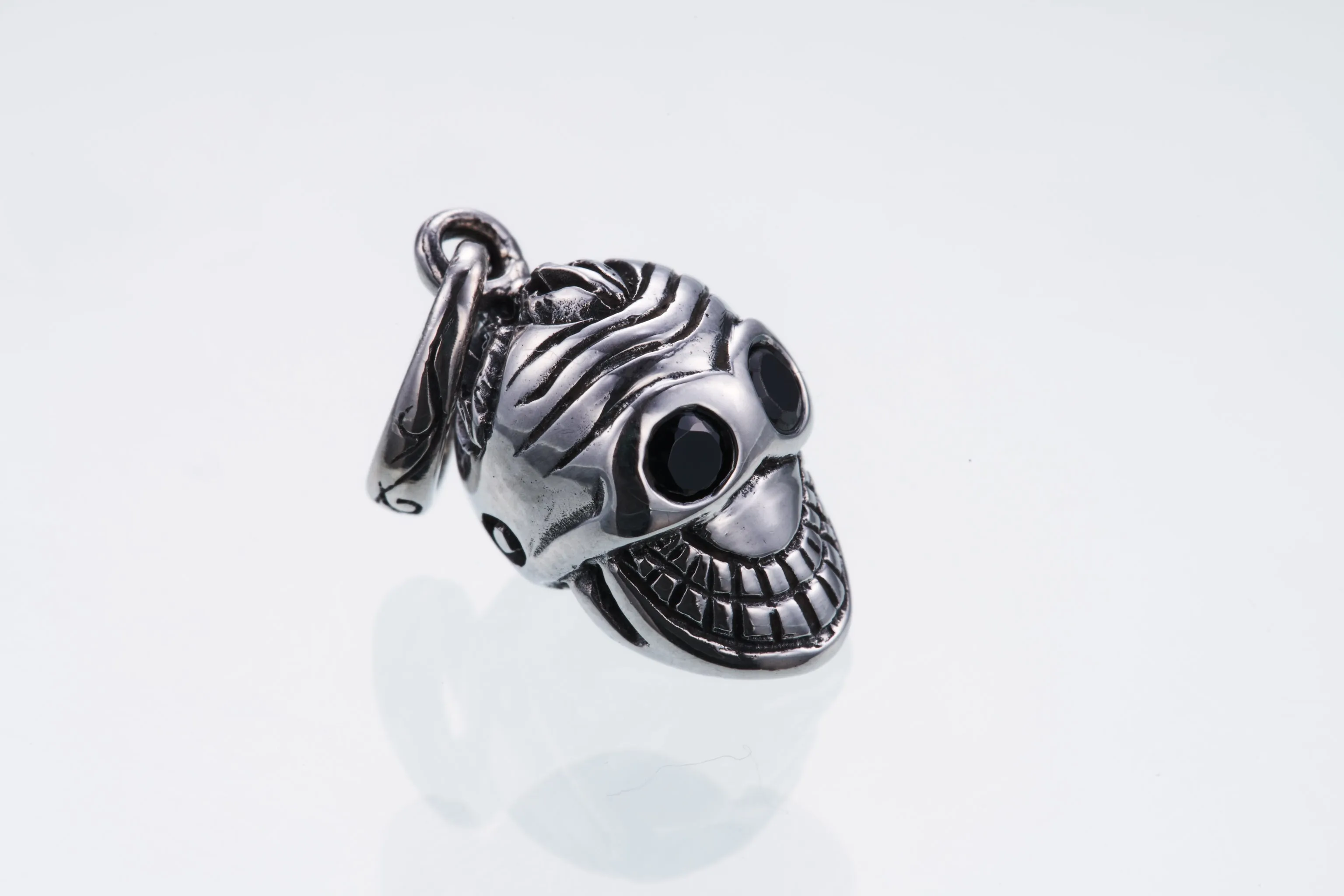 Jeweled Tibetan Smile Skull Charm : (Garnet CZ)