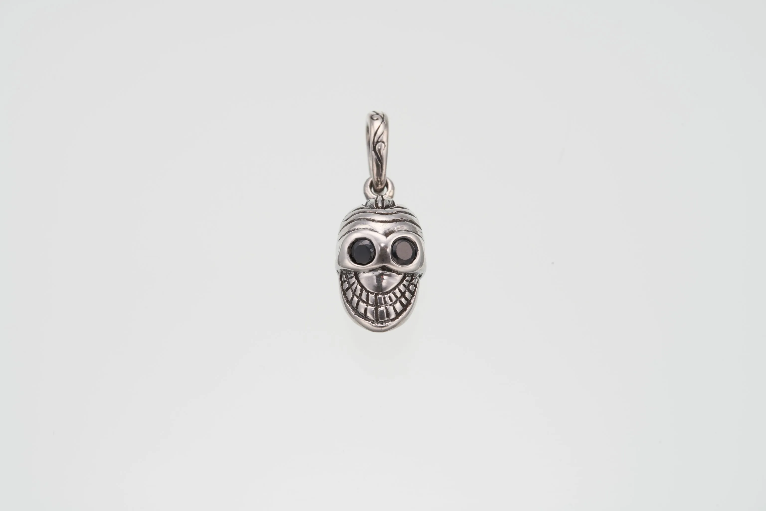 Jeweled Tibetan Smile Skull Charm : (Garnet CZ)